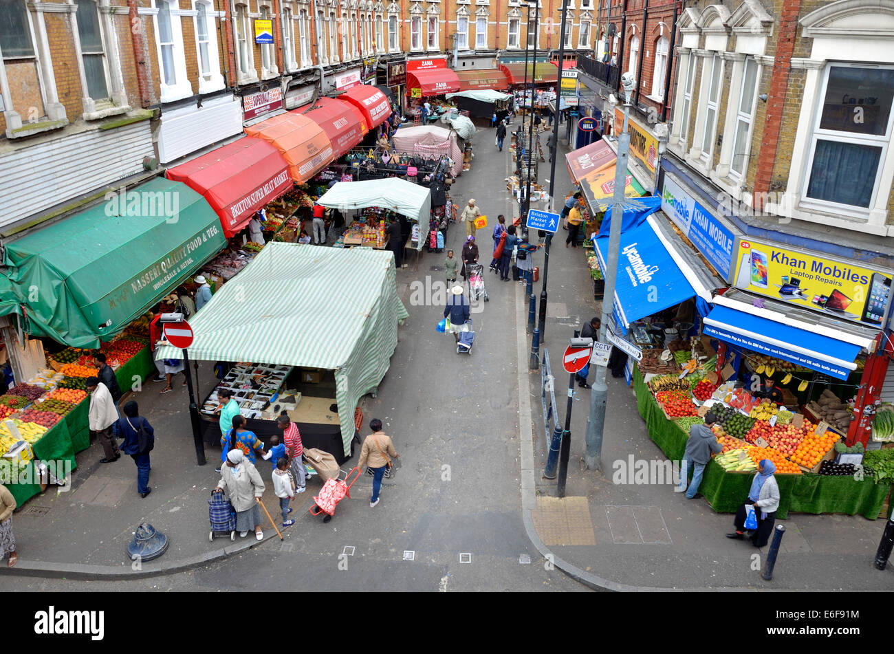 London, England, UK. Brixton market - Electric Avenue, seen from the platform of Brixton Station Stock Photo