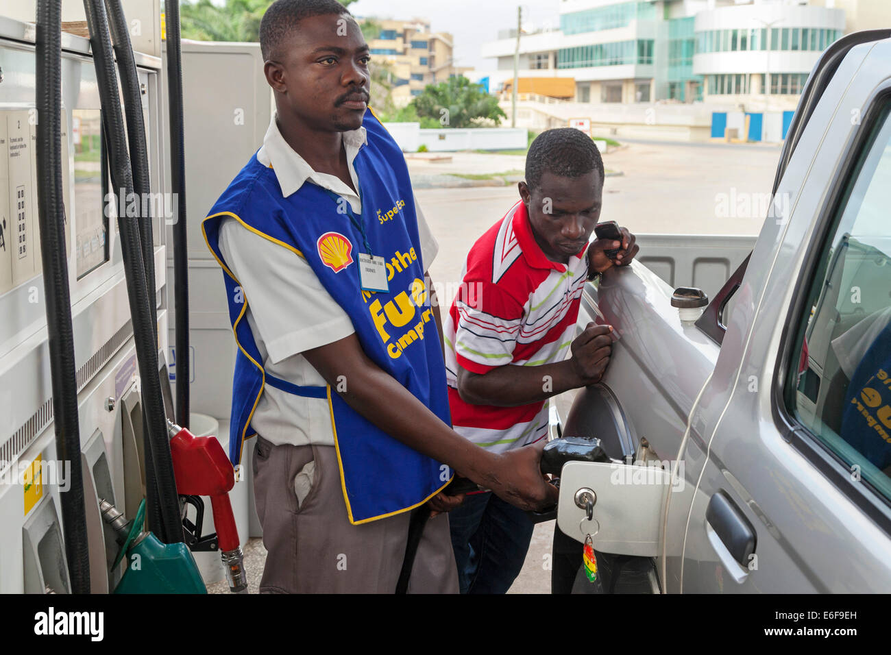 Staff and customer at petrol filling station, Accra, Ghana, Africa