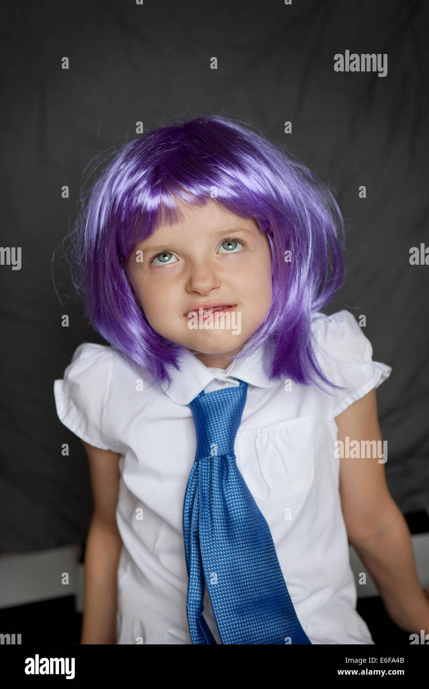 Eye rolling child dressed in a shirt and tie Stock Photo