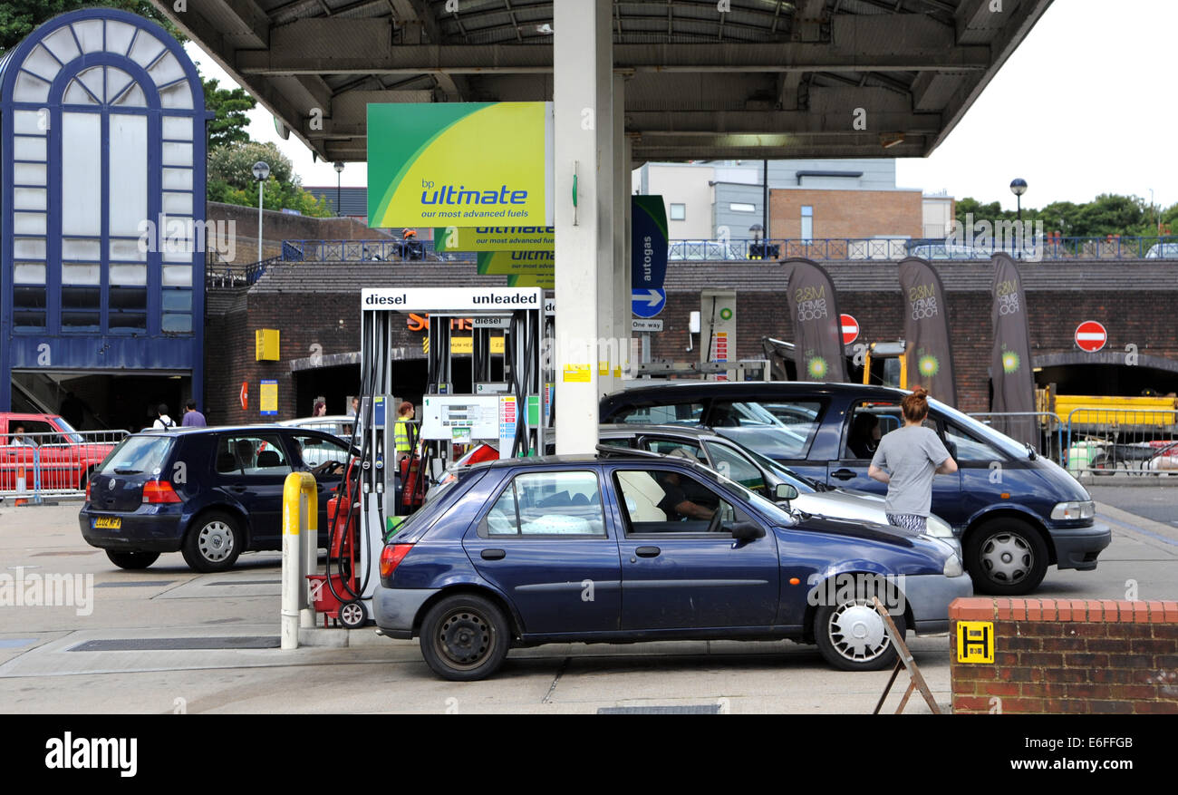 Brighton UK - Drivers filling up with fuel petrol at BP service station Stock Photo