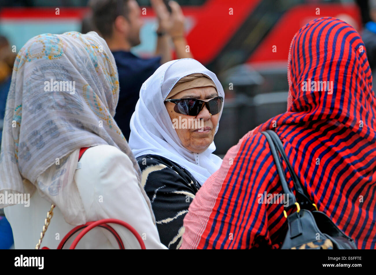 London, England, UK. Muslim women in headscarves in Trafalger Square Stock Photo