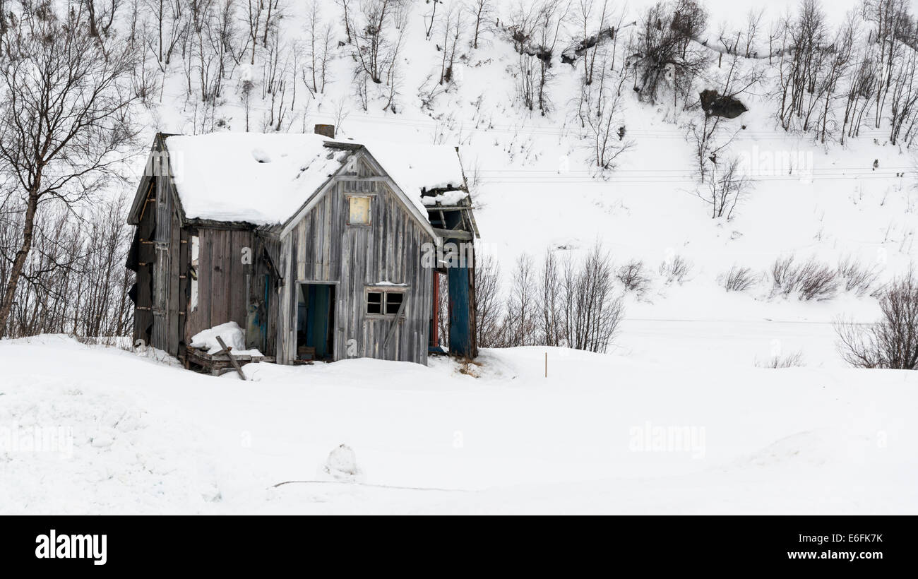 Old abandoned house in the snow Stock Photo