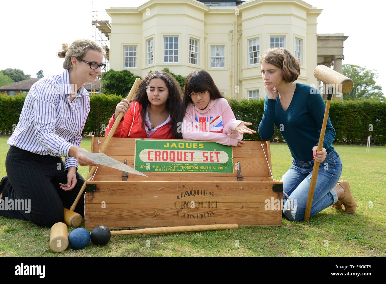 Concord College Acton Burnell Foreign students learning the rules of Croquet from Rachel Harnell, pastoral assistant and under 12's leader student are LtoR  Amina Sharif (Saudi Arabia), Eleanor Ueda (Japan) and Olga Blinova (Russia). Stock Photo