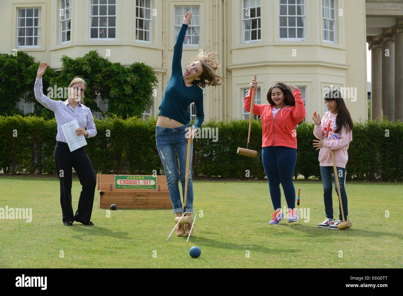 Concord College at Acton Burnell Foreign students learning Croquet. Olga Blinova celebrates her first Croquet win watched by LtoR Rachel Harnell, pastoral assistant,  Amina Sharif (Saudi Arabia), Eleanor Ueda (Japan). Stock Photo