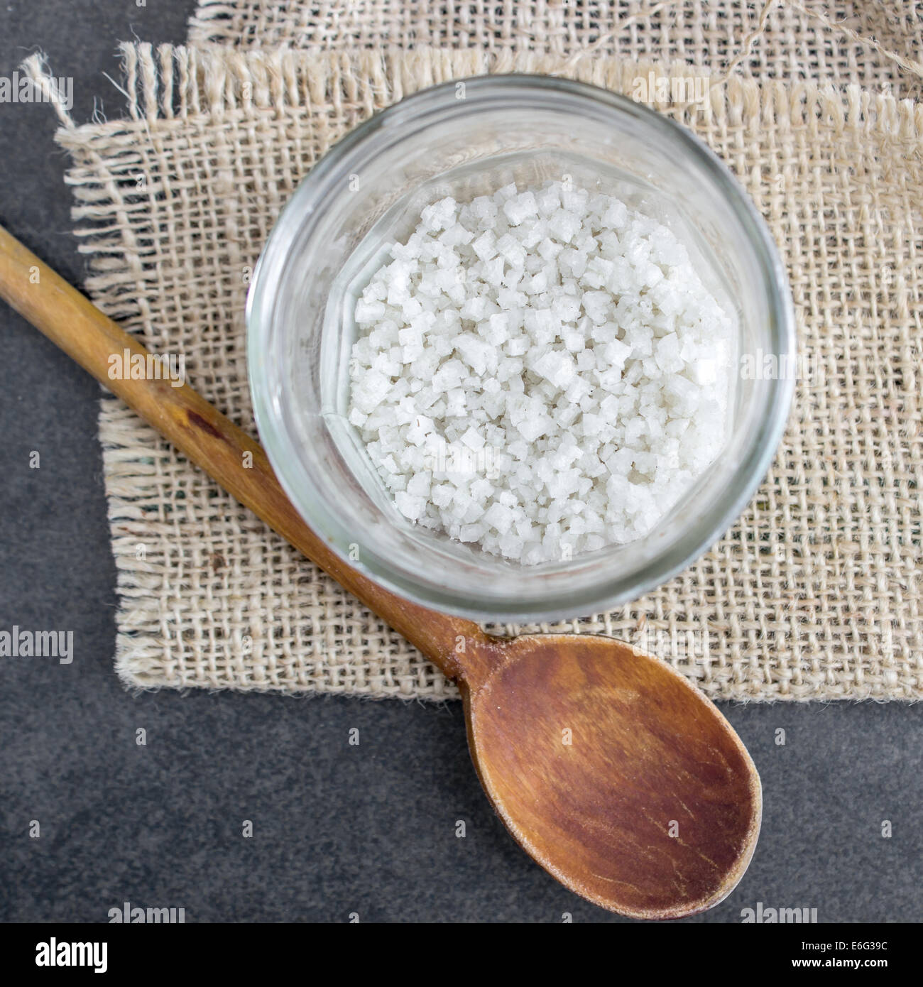 White rock salt in glass jar on table, from above Stock Photo