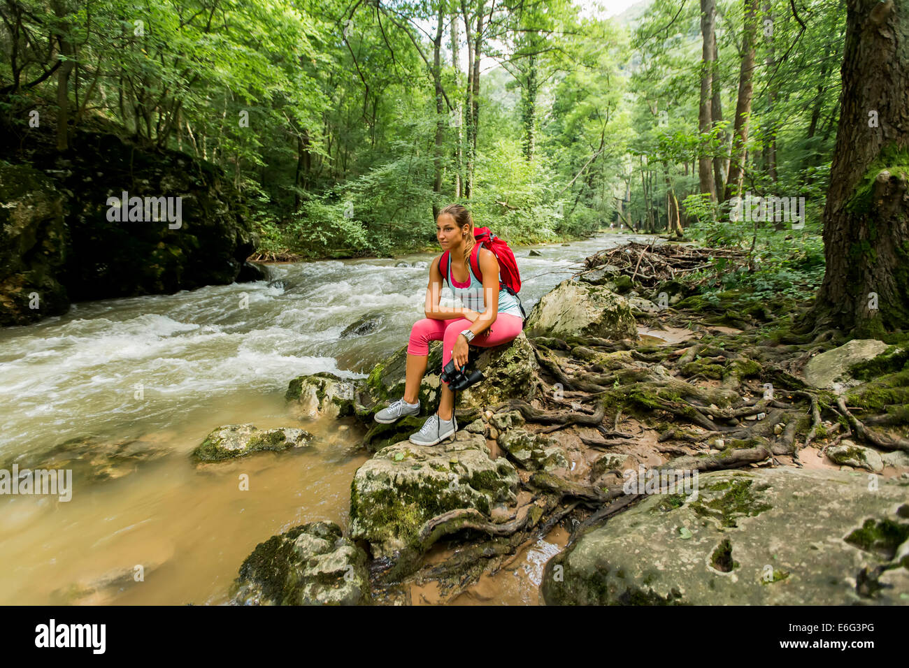Young woman hiking in the forest Stock Photo - Alamy