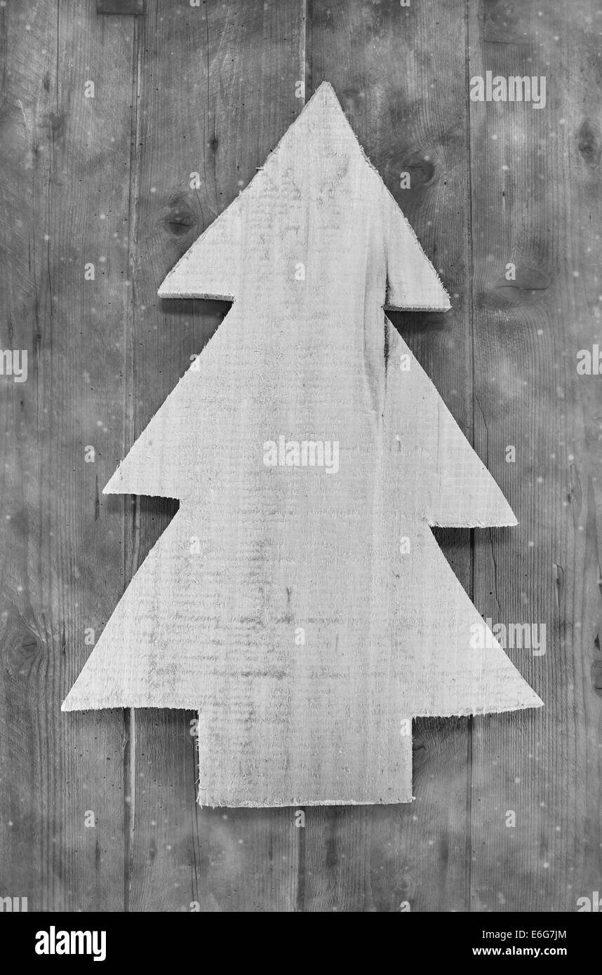 Shabby chic christmas decoration. Handmade carved tree on wooden background in grey color. Stock Photo