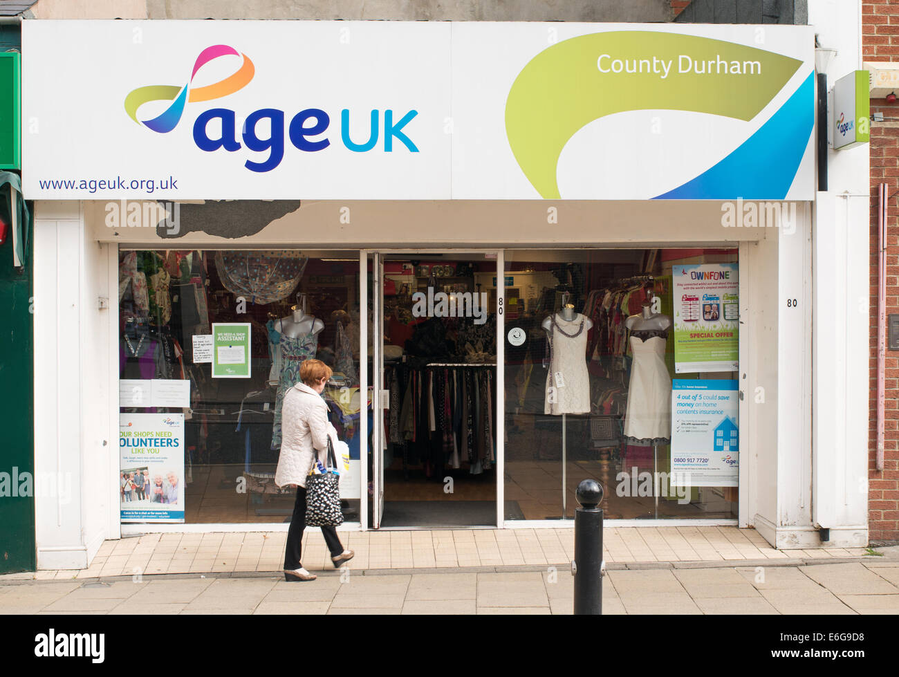 Woman entering Age UK charity shop, Chester-le-Street, north east England, UK Stock Photo