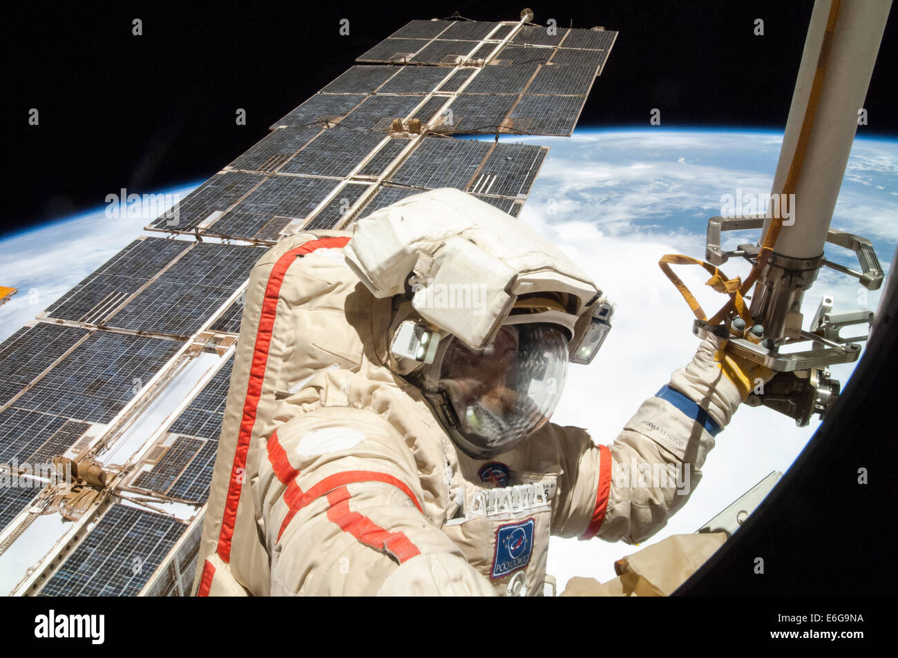 Russian cosmonauts Alexander Skvortsov with the International Space Station Expedition 40 crew works on installing experiment packages and inspecting components on the exterior of the orbital laboratory during a five-hour, 11-minute spacewalk August 18, 2014 in Earth Orbit. Stock Photo