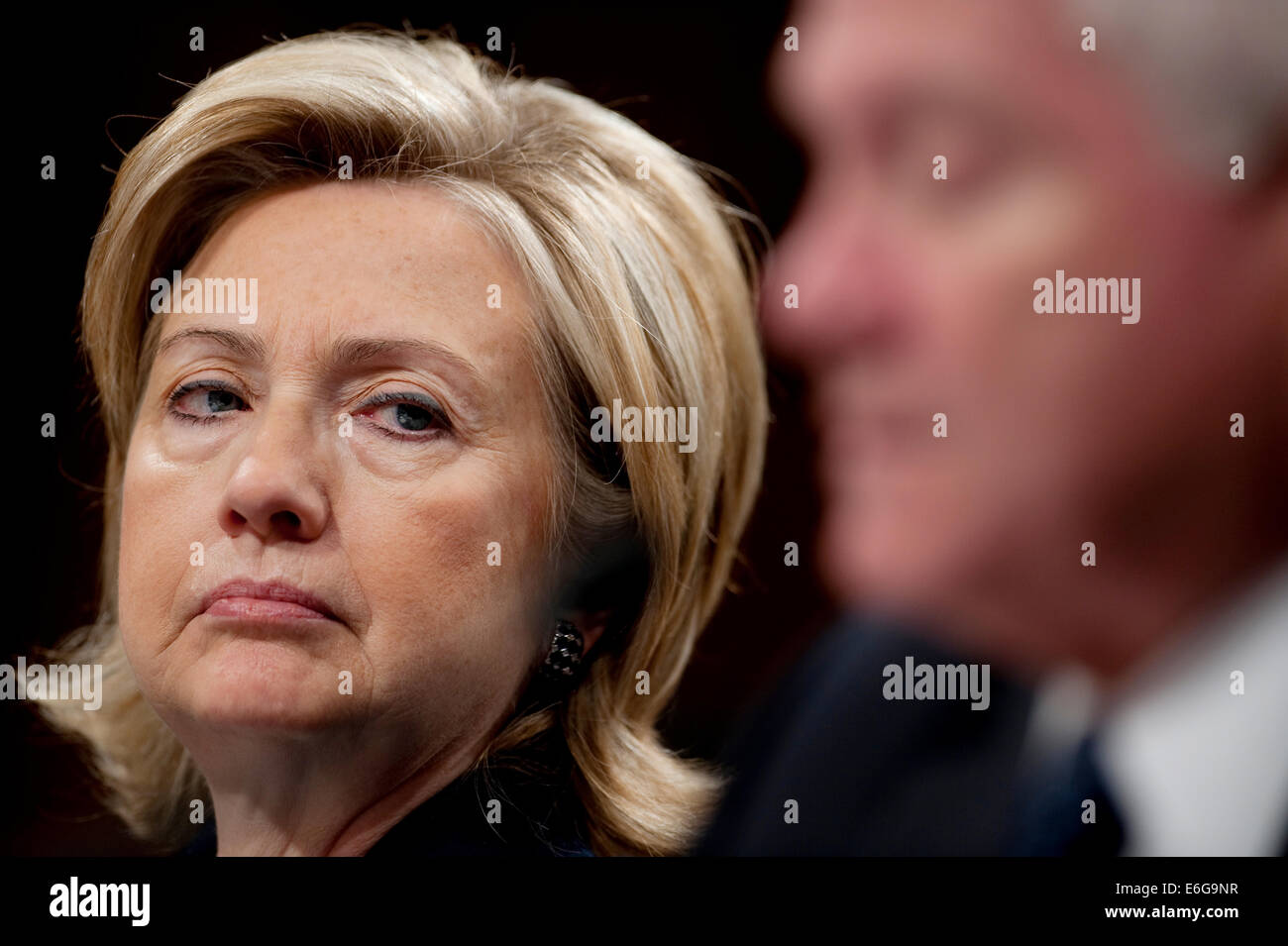 US Secretary of State Hillary Rodham Clinton listens to Defense Secretary Robert M. Gates testify before the Senate Foreign Relations Committee on the troop surge sending an additional 30,000 troops to Afghanistan in the Hart Senate Office Building December 3, 2009 in Washington, DC. Stock Photo