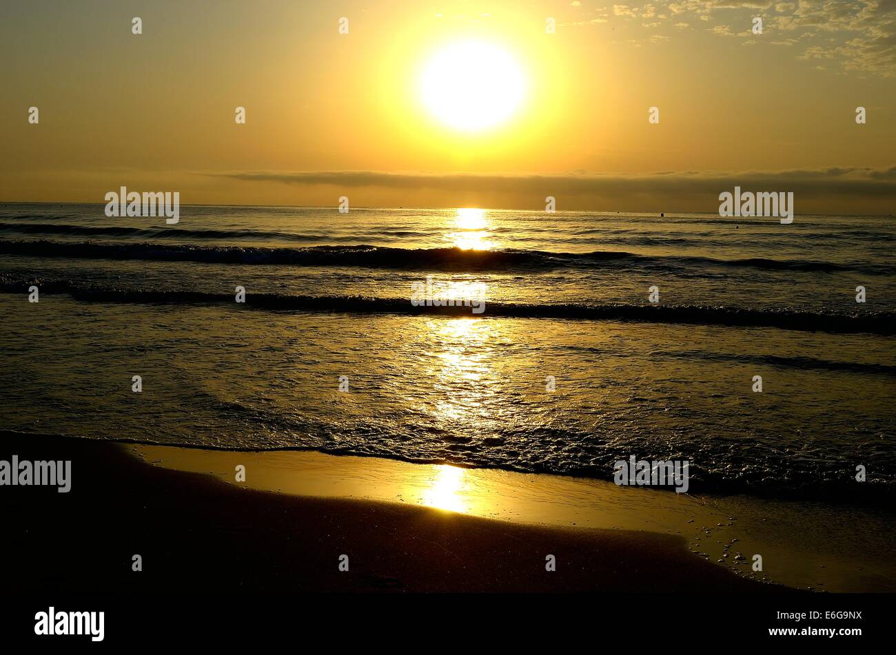 A sunrise on a Spanish beach Stock Photo - Alamy