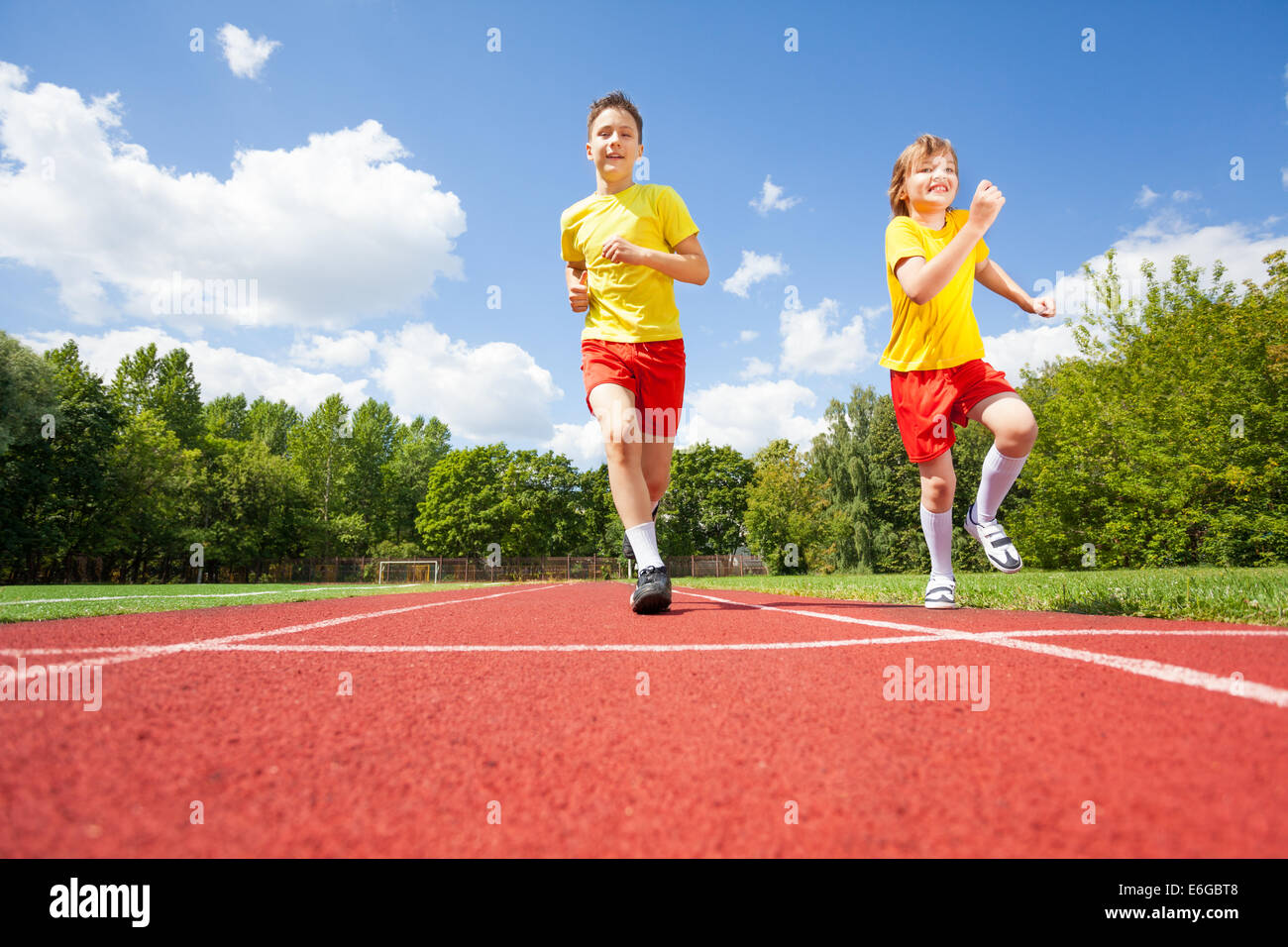 Two boys run while competing to each other Stock Photo