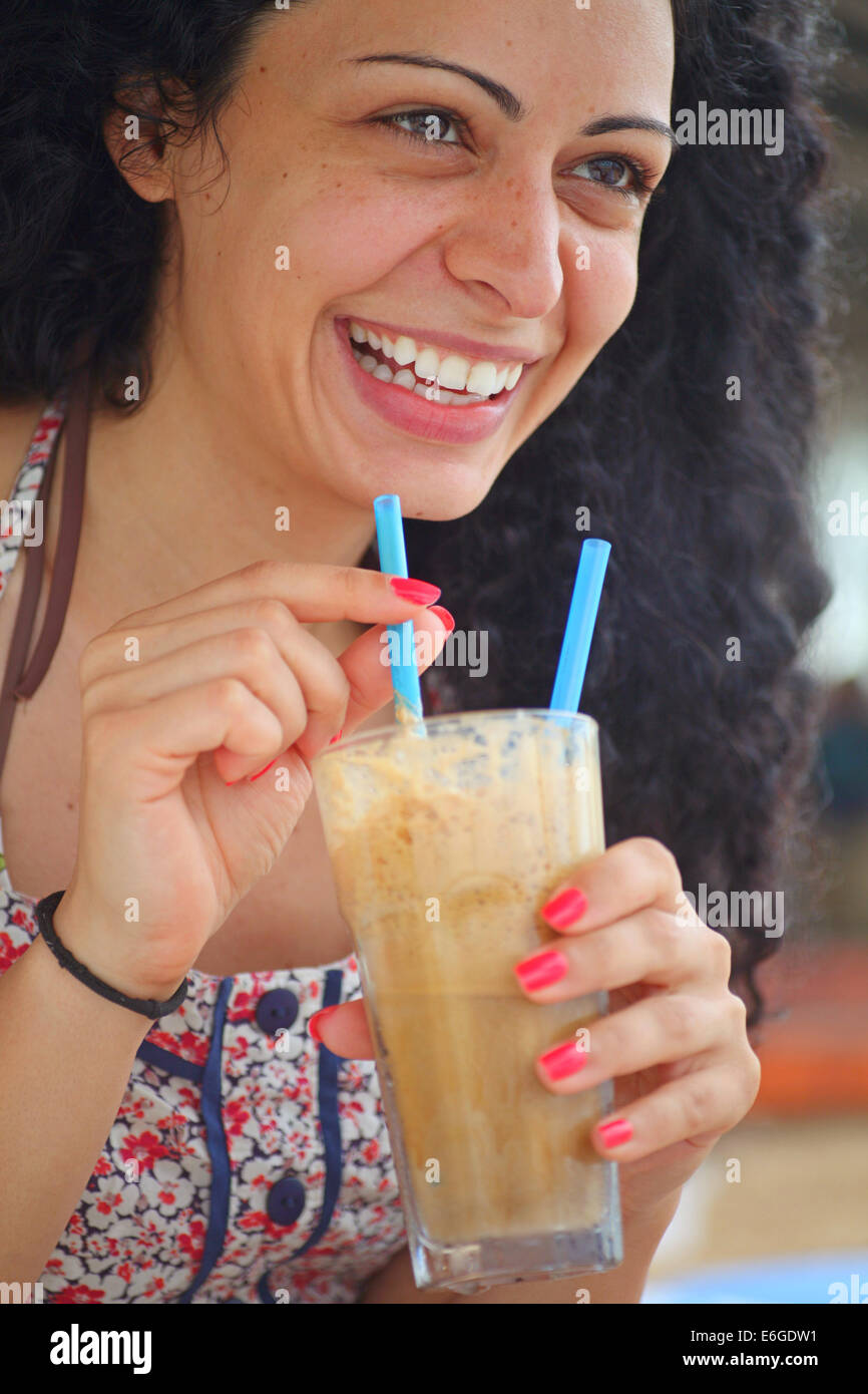 Young Beautiful Brunette Girl Drinking Iced Coffee And Having Fun Young Beautiful Brunette Girl Drinking Iced Coffee And Having Fun