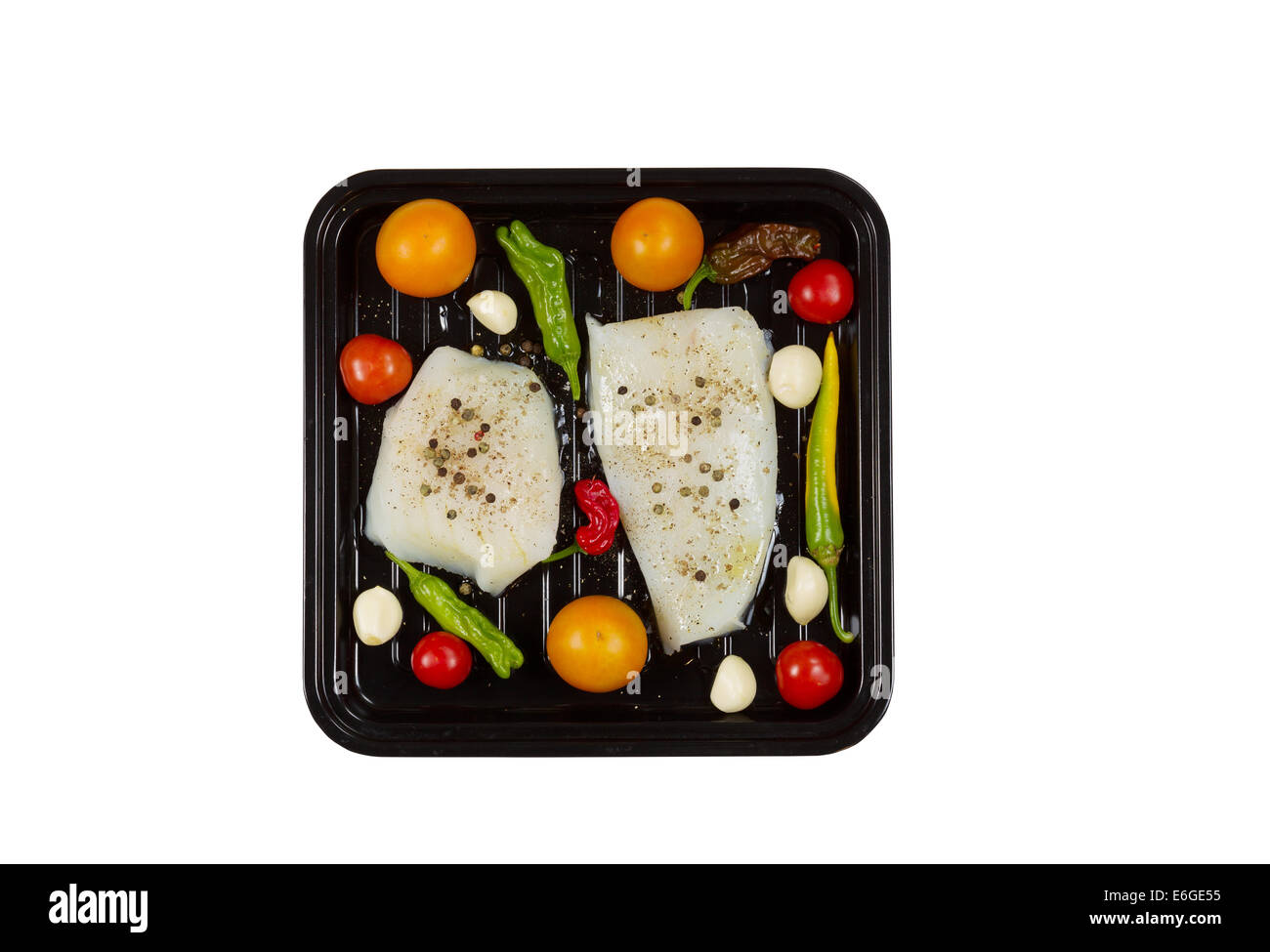 Top view of fresh raw Cod Fish Fillets in cooking pan with tomatoes ...