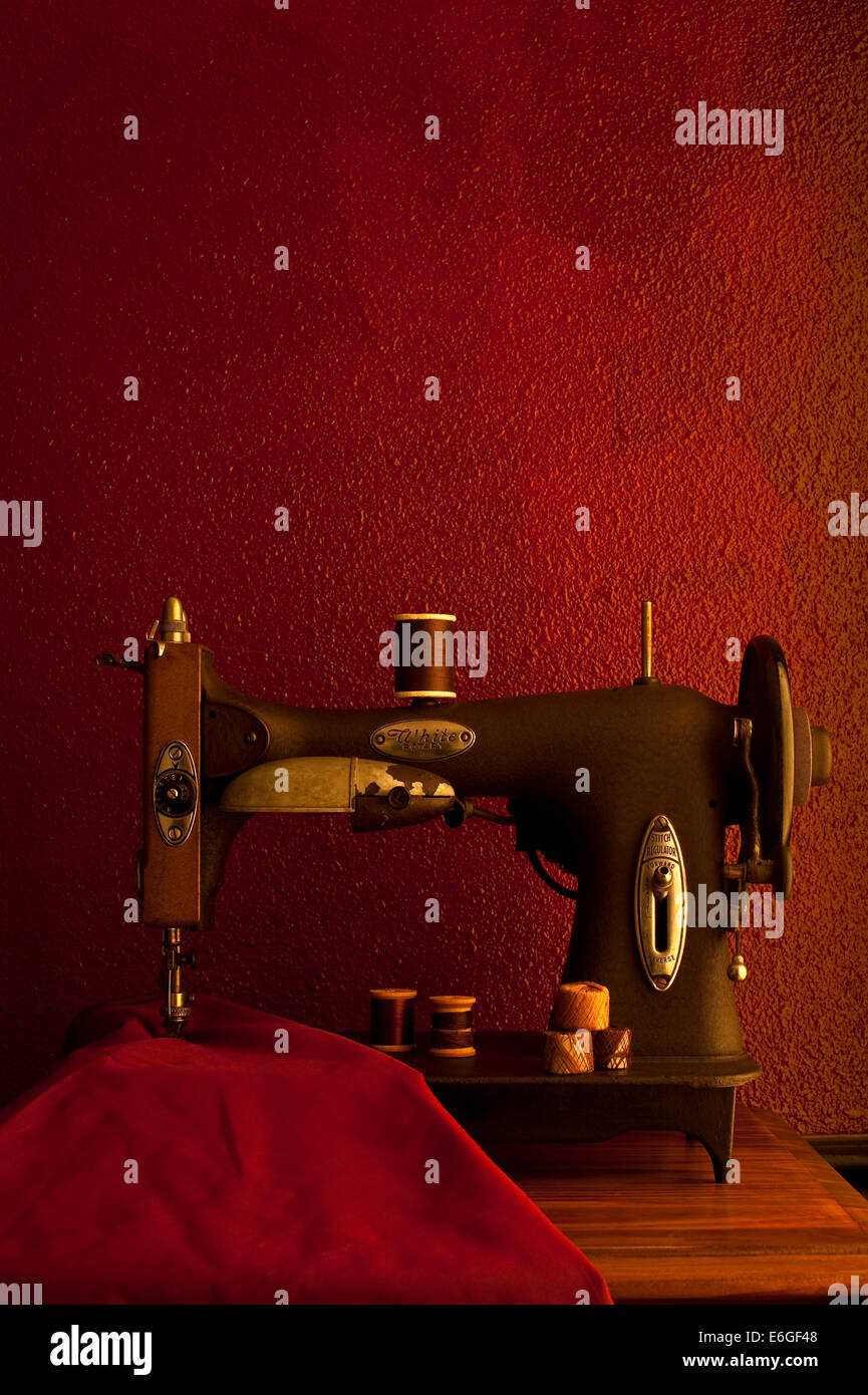 Antique sewing machine with fabric and thread spools Stock Photo Alamy