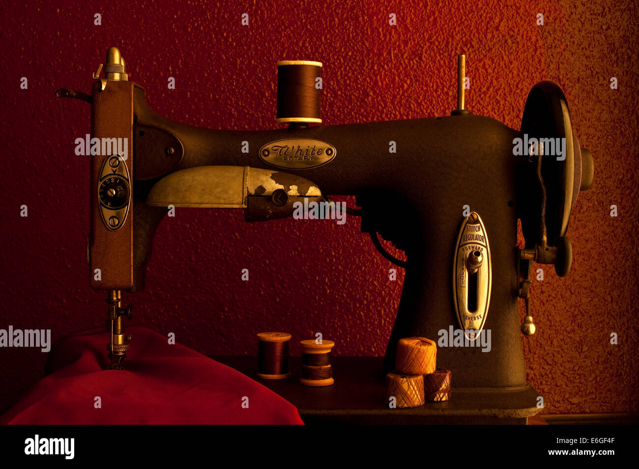 Antique sewing machine with fabric and thread spools Stock Photo - Alamy
