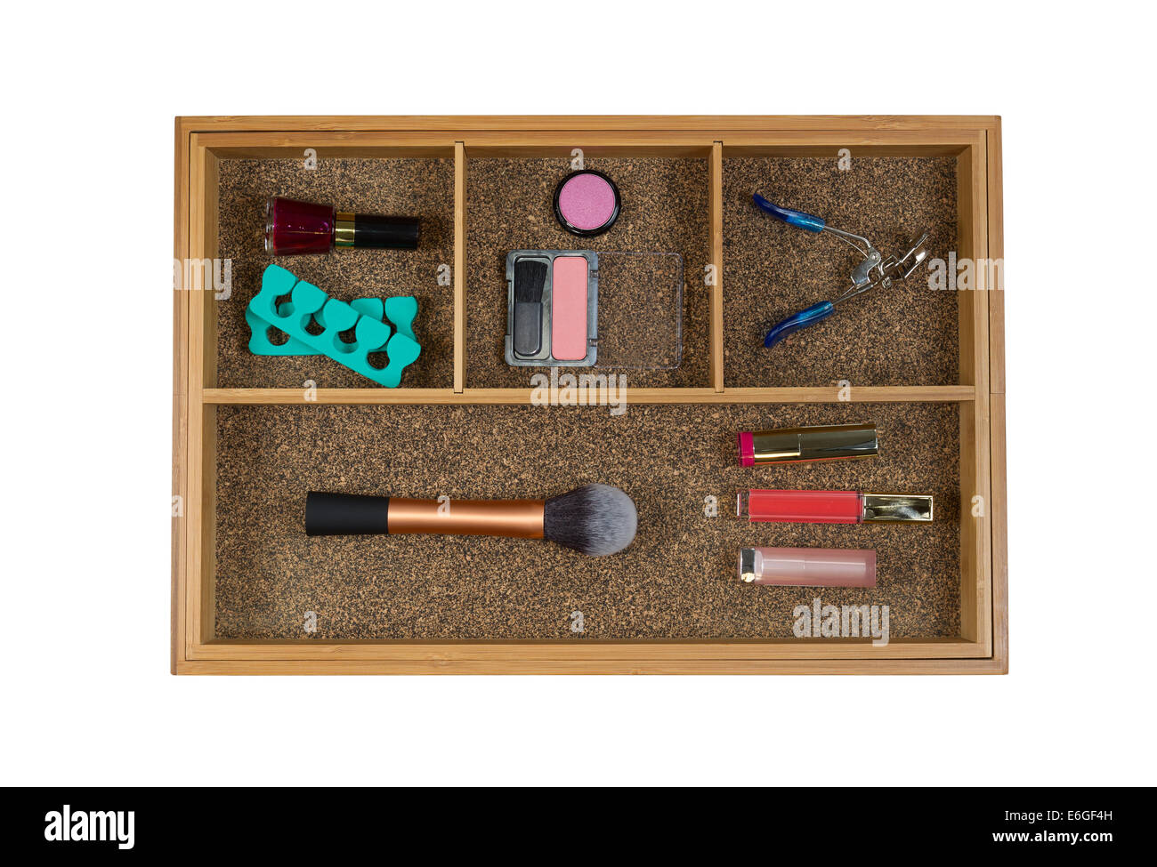 Top view of storage drawer with woman accessories consisting blush, brush, eye lash curler, lip stick, and nail polish isolated Stock Photo