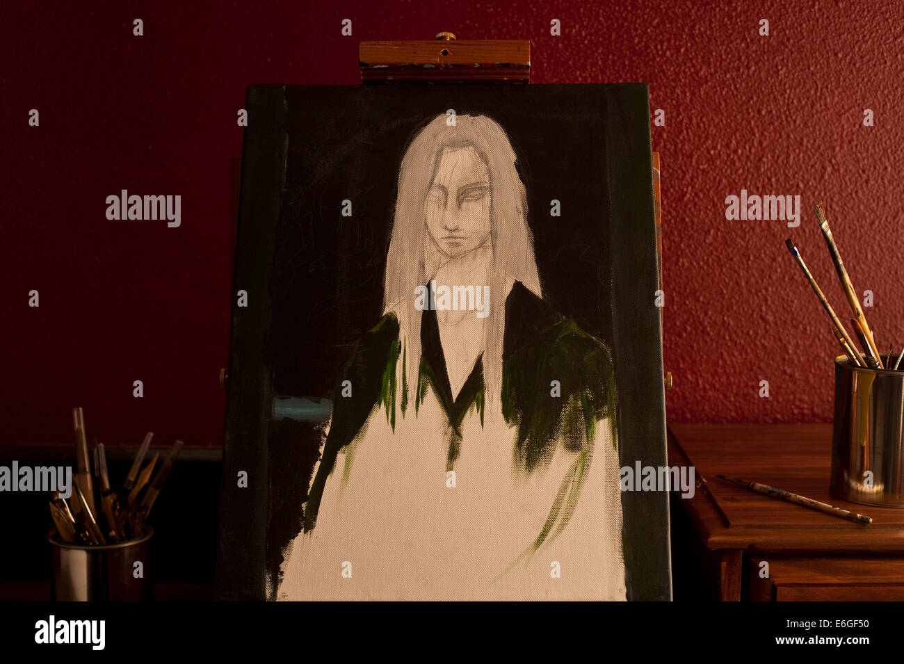 Painting of young woman on easel in artist studio with window light ...