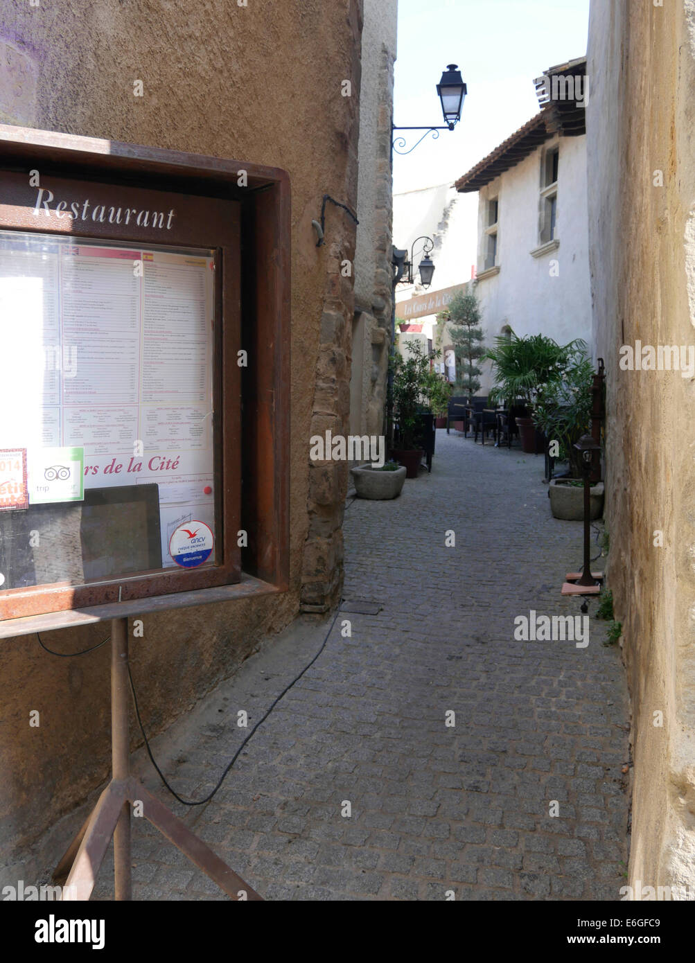 Restaurant sign in old cobbled back street in the walled city of Carcassonne Stock Photo