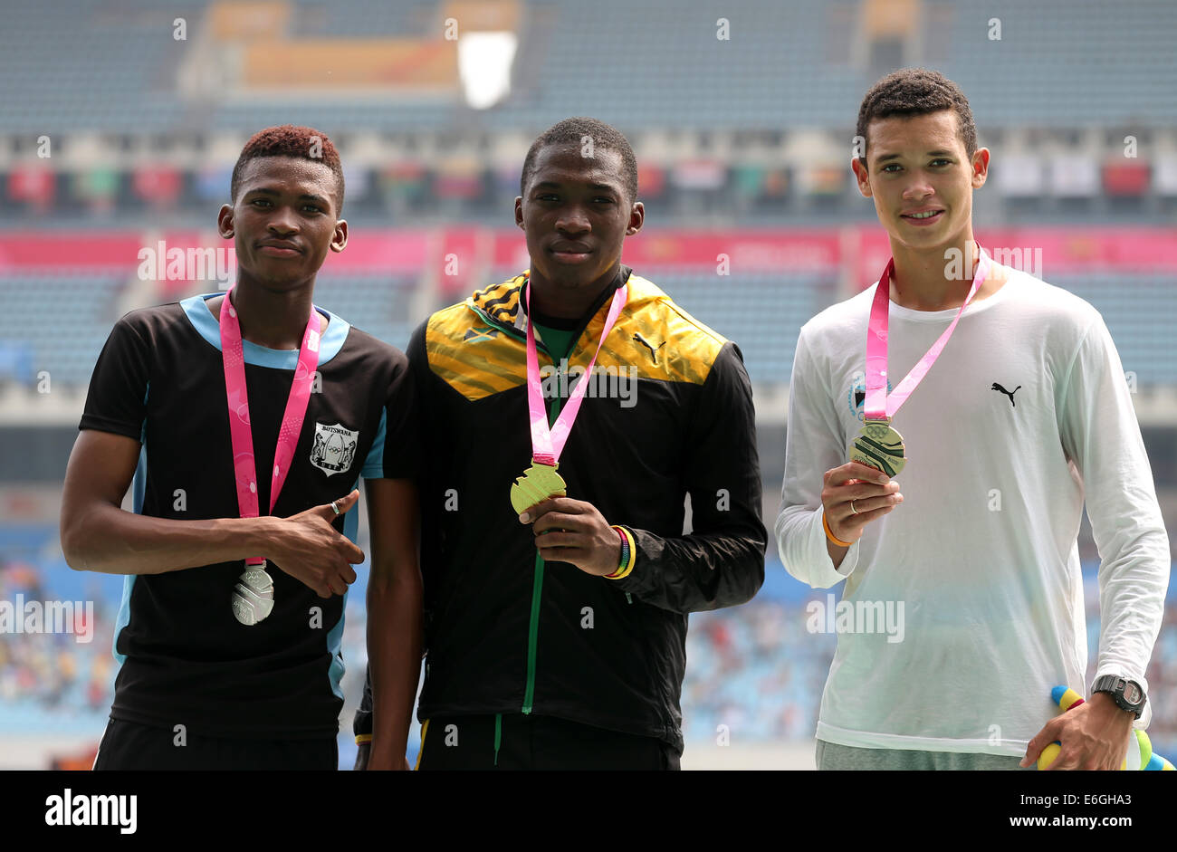 Nanjing, China's Jiangsu Province. 23rd Aug, 2014. Gold medalist Martin Manley (C) of Jamaica, silver medalist Karabo Sibanda (L) of Botswana and bronze medalist Henry Delauze of Bahamas pose on the podium during the awarding ceremony of the men?s 400m Final of athletics event at the Nanjing 2014 Youth Olympic Games in Nanjing, capital of east China's Jiangsu Province, Aug. 23, 2014. Credit:  Yang Lei/Xinhua/Alamy Live News Stock Photo