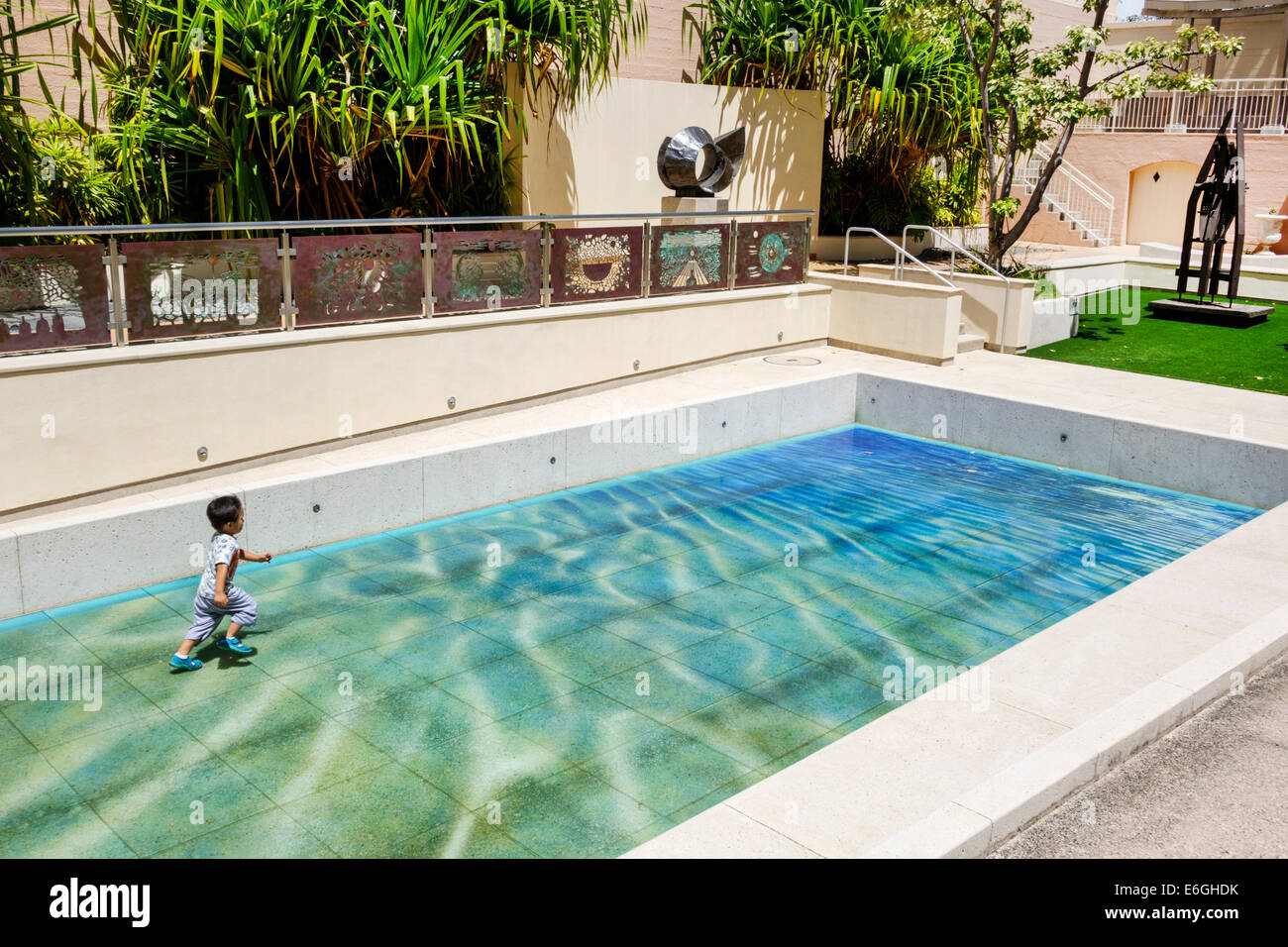 Honolulu Hawaii,Oahu,Hawaiian,Hawaii State Art Museum,Foundation on Culture & the Arts,installation,swimming pool,tile,illusion,water,Asian boy boys,m Stock Photo