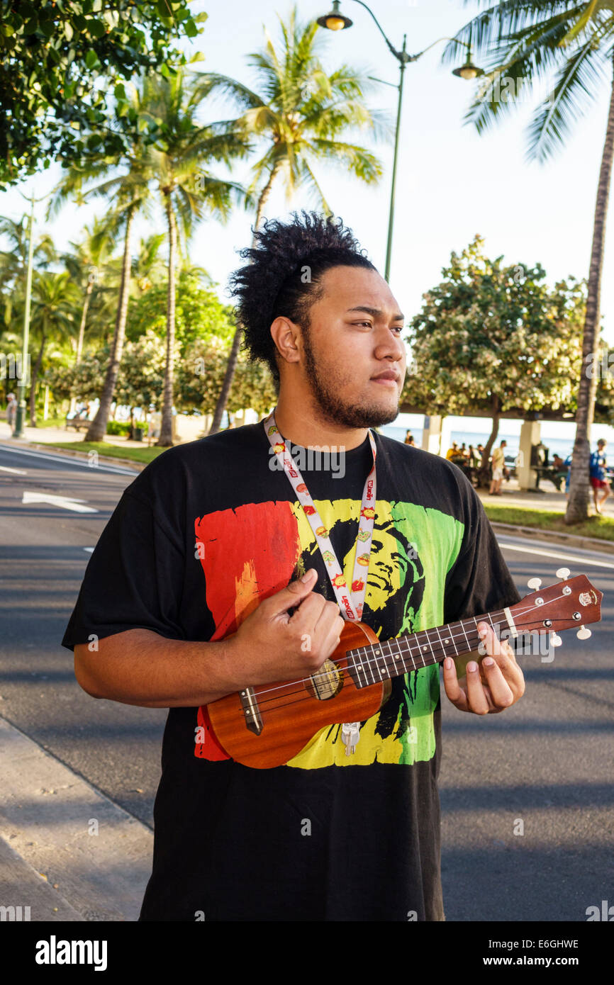 Hawaii,Hawaiian,Honolulu,Waikiki Beach,Kalakaua Avenue,man men male,playing ukulele,USA,US,United,States,America Polynesia,HI140325095 Stock Photo