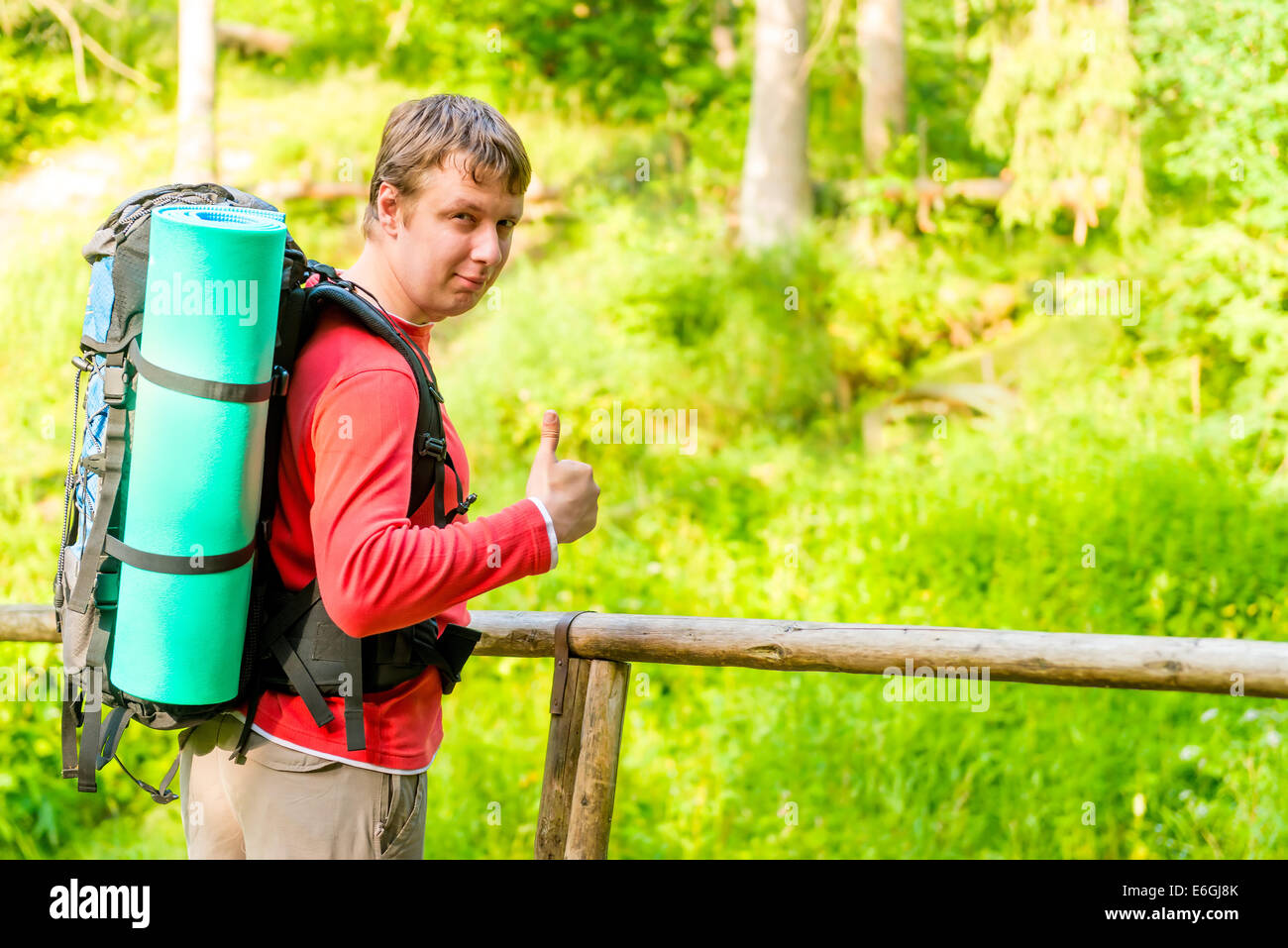 satisfied man goes camping in the woods Stock Photo