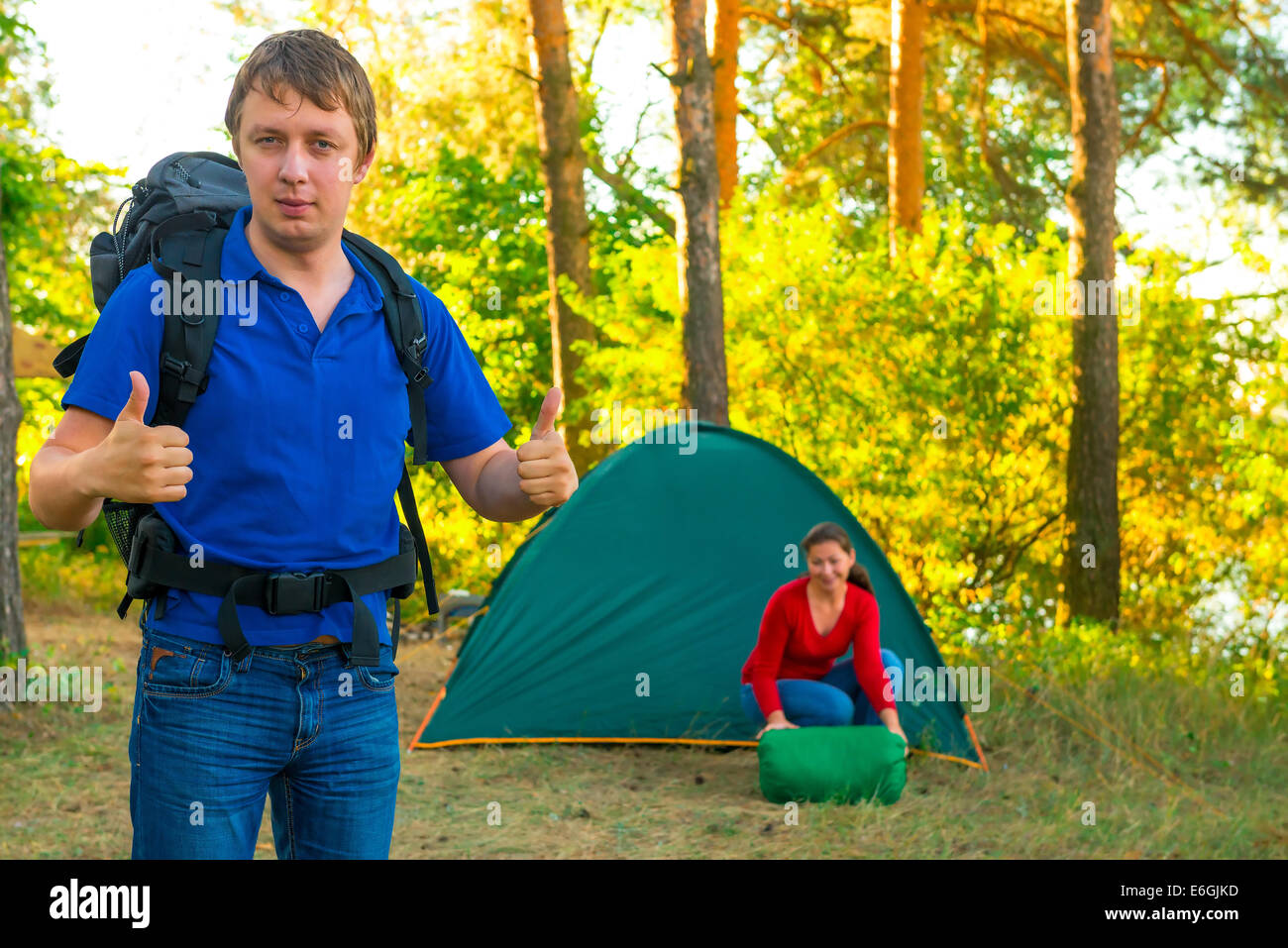successfully rested couple with tent on the nature Stock Photo - Alamy