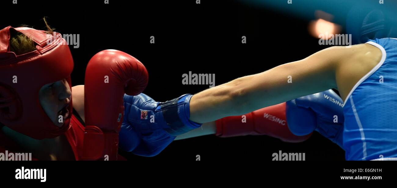 Nanjing, China?s Jiangsu Province. 23rd Aug, 2014. Monica Floridia of Italia(R)and Ciara Ginty of Ireland compete in the Women's Fly (57-60kg) preliminary of Boxing event during Nanjing 2014 Youth Olympic Games in Nanjing, capital of east China?s Jiangsu Province, on Aug. 23, 2014. Credit:  Ou Qudong/Xinhua/Alamy Live News Stock Photo