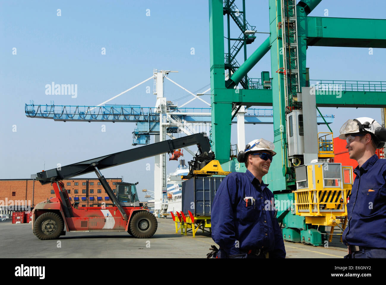 dock and port workers inside cargo-container port Stock Photo