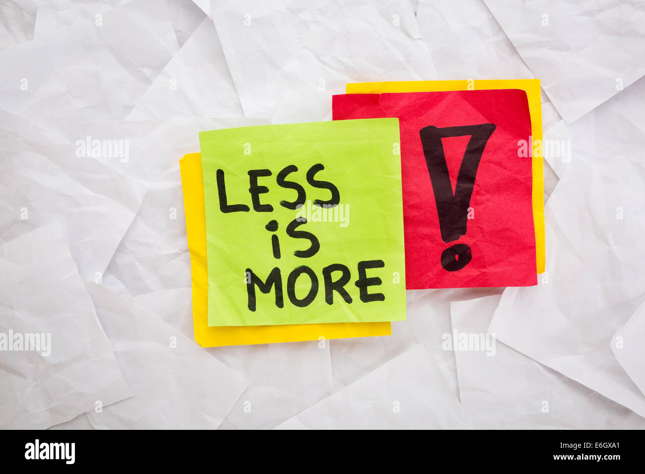 less is more - reminder or advice handwritten on colorful sticky notes - minimalist design concept Stock Photo