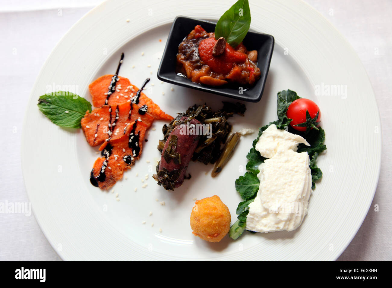 Sicilian hors d oevre called Caponata served at Hotel Eremo della Giubiliana. Stock Photo