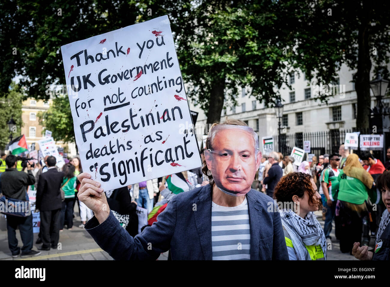 London, UK. 23rd August, 2014. A pro-Palestinian protester wearing a mask of Benjamin Netanyahu during a demonstration outside Downing street against arms sales to Israel.  Credit:  Gordon Scammell/Alamy Live News Stock Photo