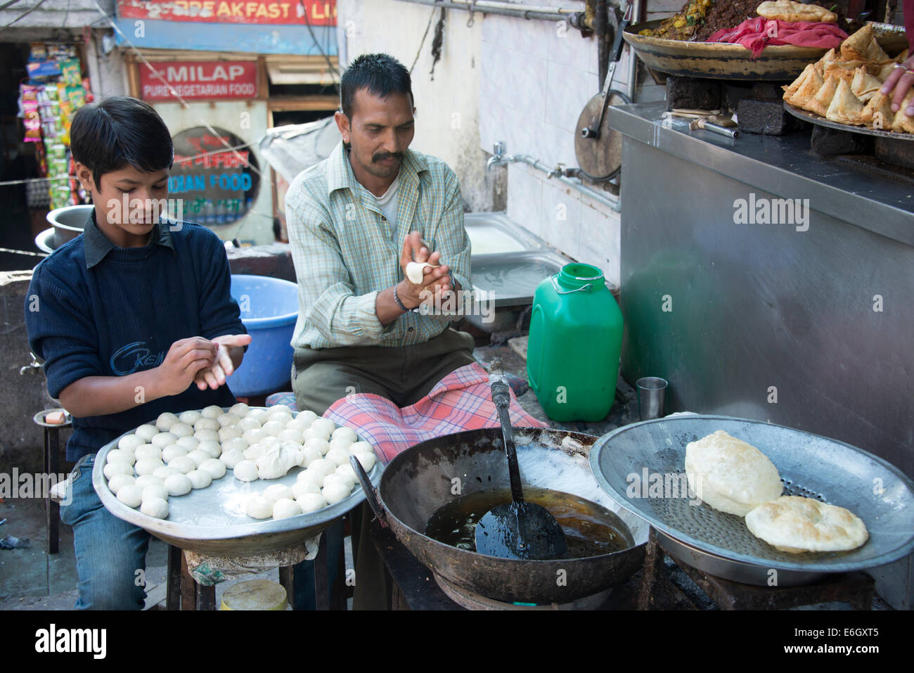 Two bakery employees making fresh Chapati (bread) at a restaurant in ...