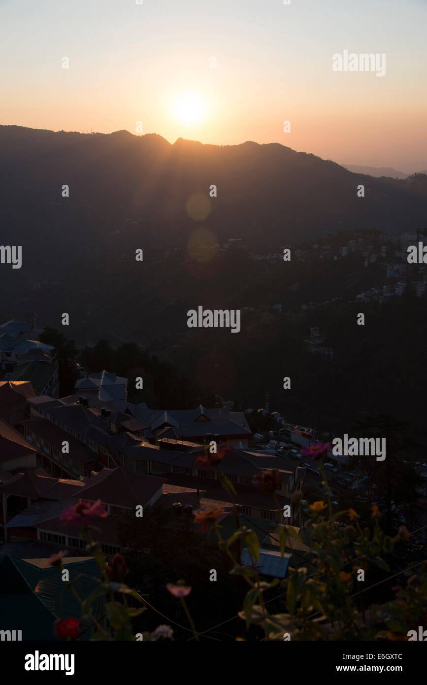 The evening sun setting behind the Himalayan foothills in Shimla, Himachal Pradesh, India, Stock Photo