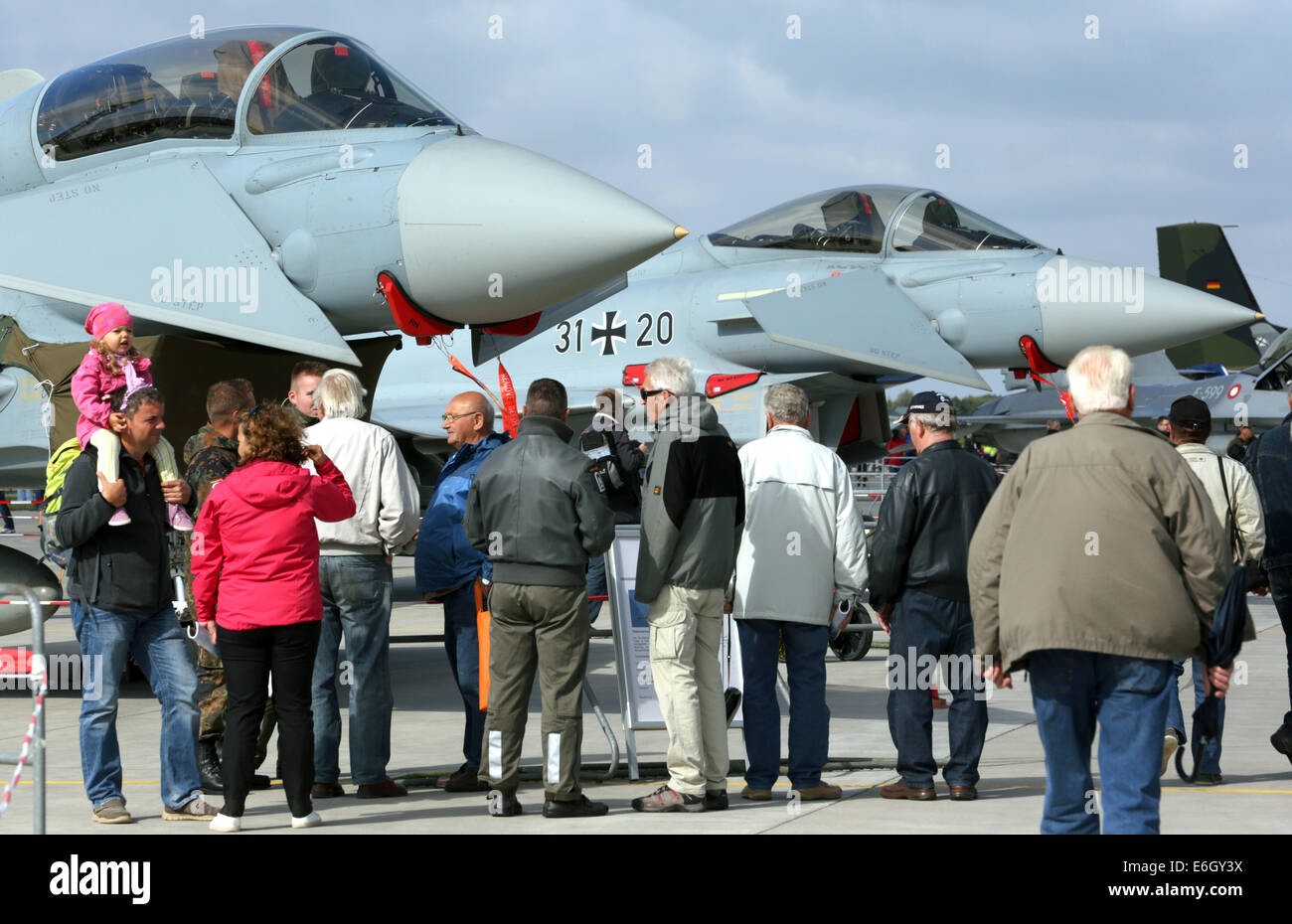 Visitors look at a Eurofighter during the open house at the tactical