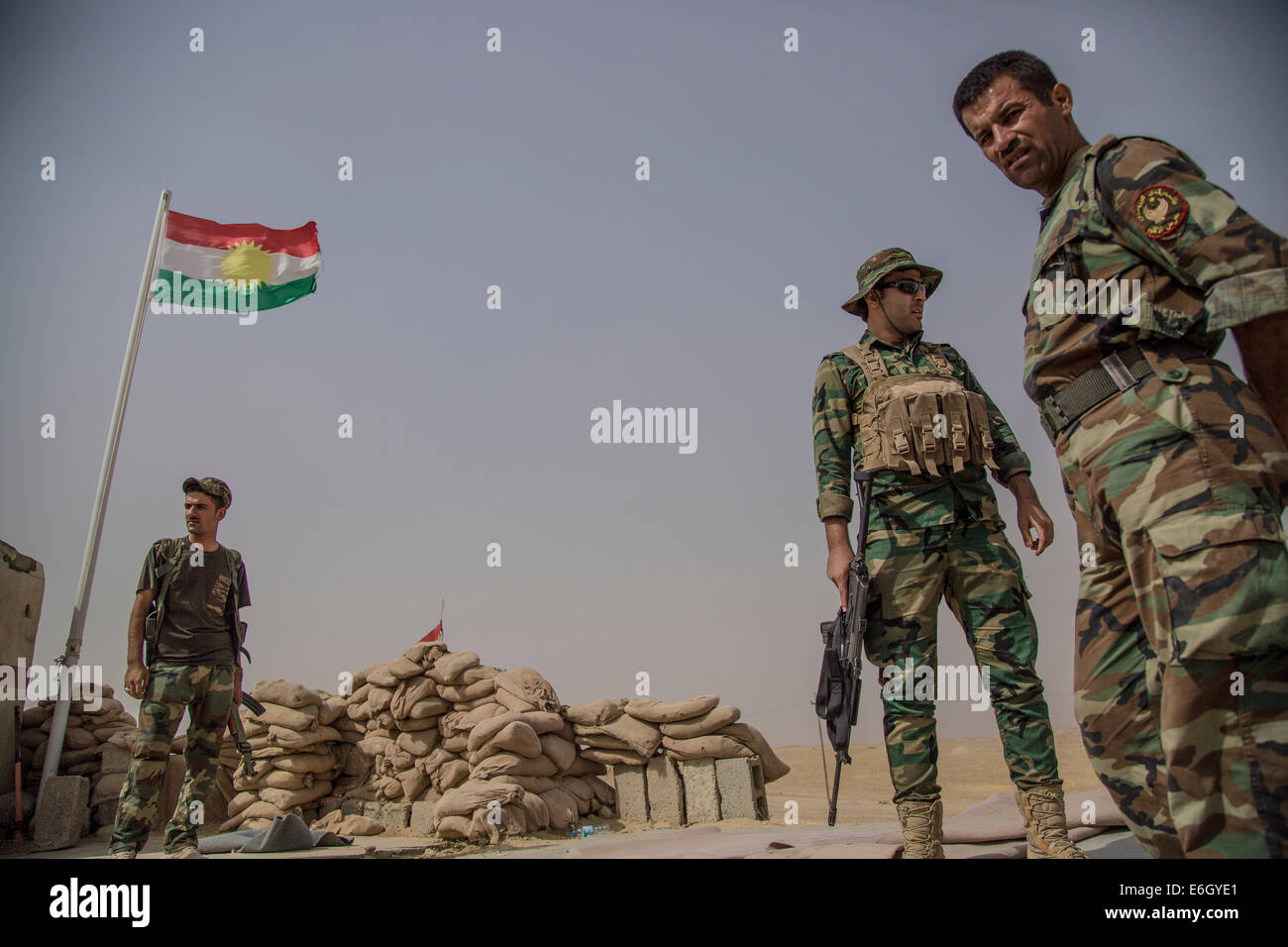 Peshmerga soldiers stand guard at a military outpost located at the ...