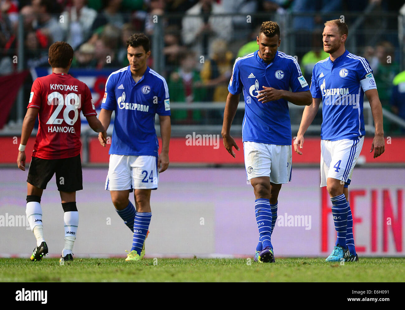 Hanover's Hiroshi Kiyotake (L), Schalke's Kaan Ayhan, Eric Maxim Choupo-Moting (2-R) and Benedikt Hoewedes (R) during the German Bundesliga match between Hannover 96 and FC Schalke 04 at HDI Arena in Hanover, Germany, 23 August 2014. Photo: PETER STEFFEN/dpa (ATTENTION: Due to the accreditation guidelines, the DFL only permits the publication and utilisation of up to 15 pictures per match on the internet and in online media during the match.) Stock Photo
