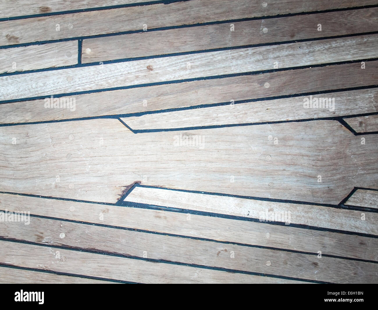aged ships deck in teak with black caulking Stock Photo