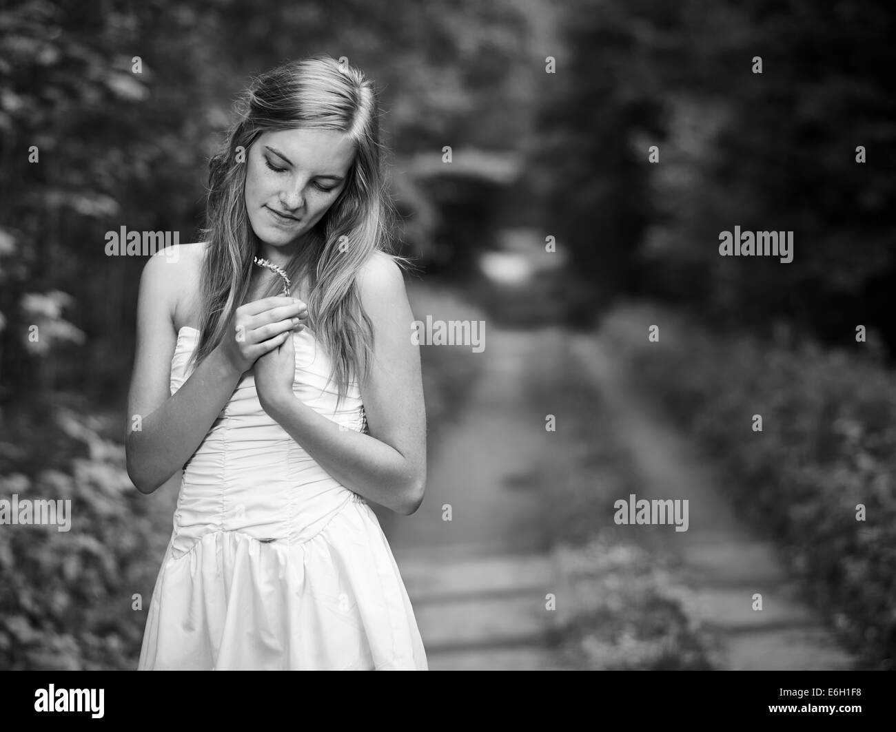 Natural beautiful young woman, rural landscape on background, black and white image Stock Photo