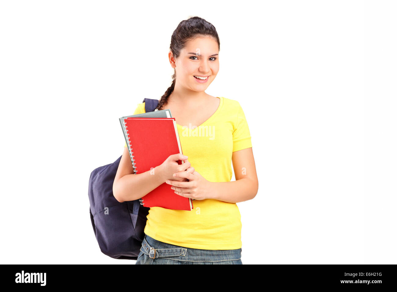 Schoolgirl holding books isolated on white background Stock Photo - Alamy