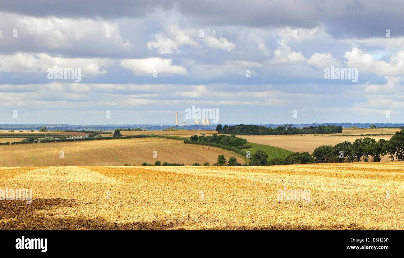 An English Rural Landscape in Oxfordshire with fields of golden wheat stubble and Power station in the distance Stock Photo