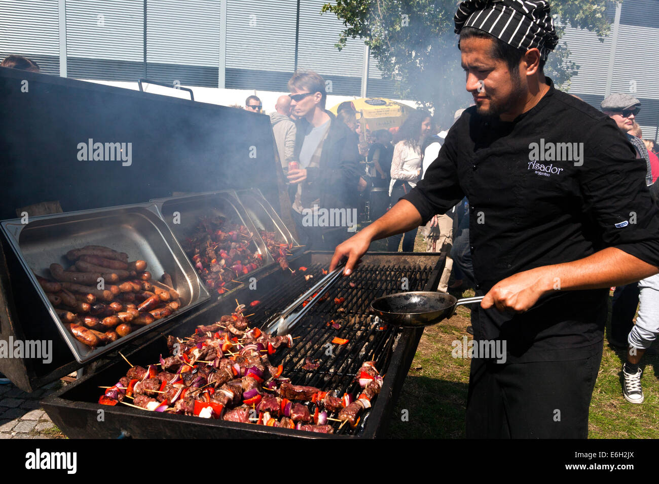 Copenhagen, Denmark. 23rd August, 23rd, 2014. Chef Raul from the Argentinian restaurant, Asador, prepares one of his favor street dishes, Pepito & Choripán, at the Copenhagen Cooking Festival, which runs until next Sunday.  Here we are at the venue at Prags Boulevard where some 100 stalls are present.  Over the coming week a total of over 150 street events take place, where many of the best restaurants offer their gastronomy to a bargain price. Among others 10 Scandinavian Michelin and other top gourmet restaurants presents their version of ”Nordic Taste” at the Gefion Fountain next Sunday © O Stock Photo