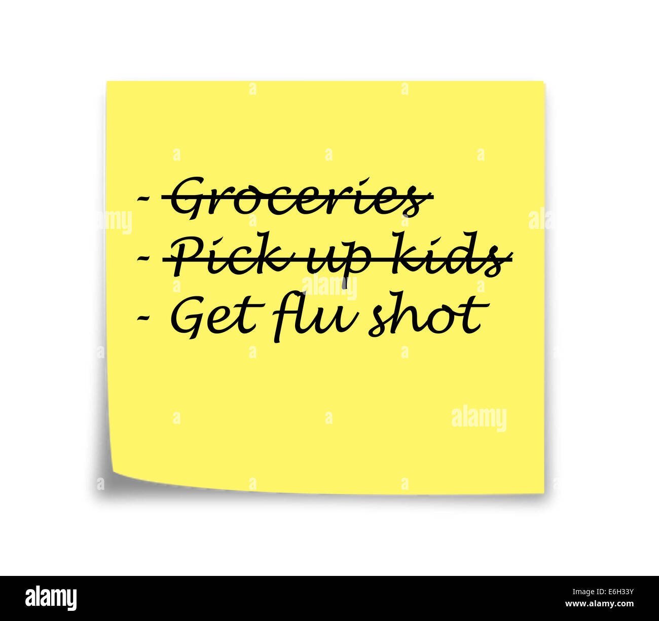 Sticky note reminder to get flu shot, black on yellow Stock Photo