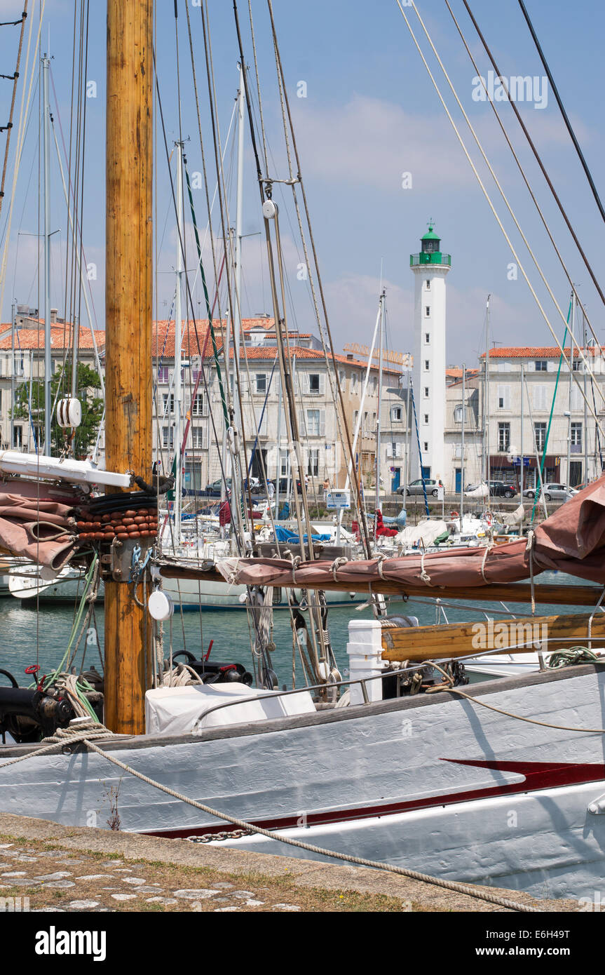 Old lighthouse, Feu Postérieur, seen through masts of boats La Rochelle harbour, Charente-Maritime, France, Europe Stock Photo