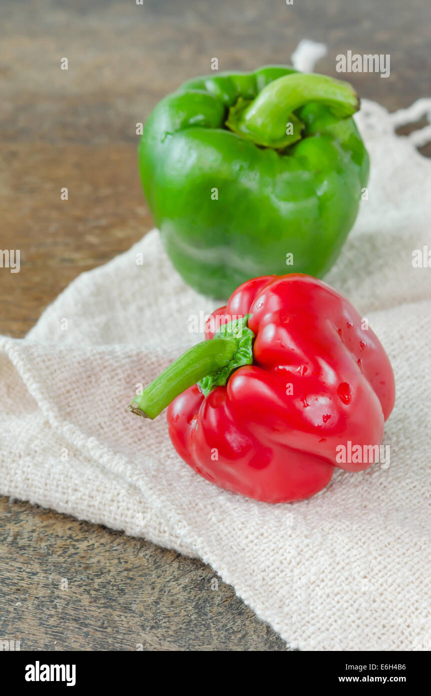 red and green bell peppers on wooden table Stock Photo