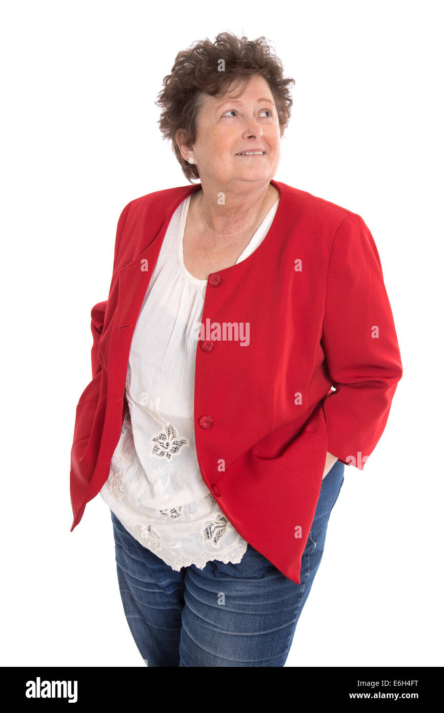 Portrait: Happy isolated senior woman wearing red jacket looking sideways to text. Stock Photo