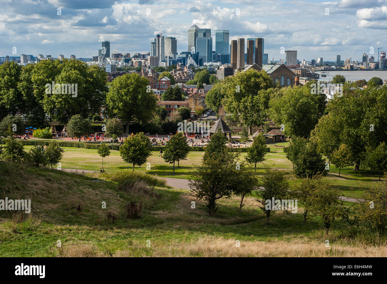 The financial district of Canary Wharf in London under dramatic sky seen from Greenwich Park. Stock Photo