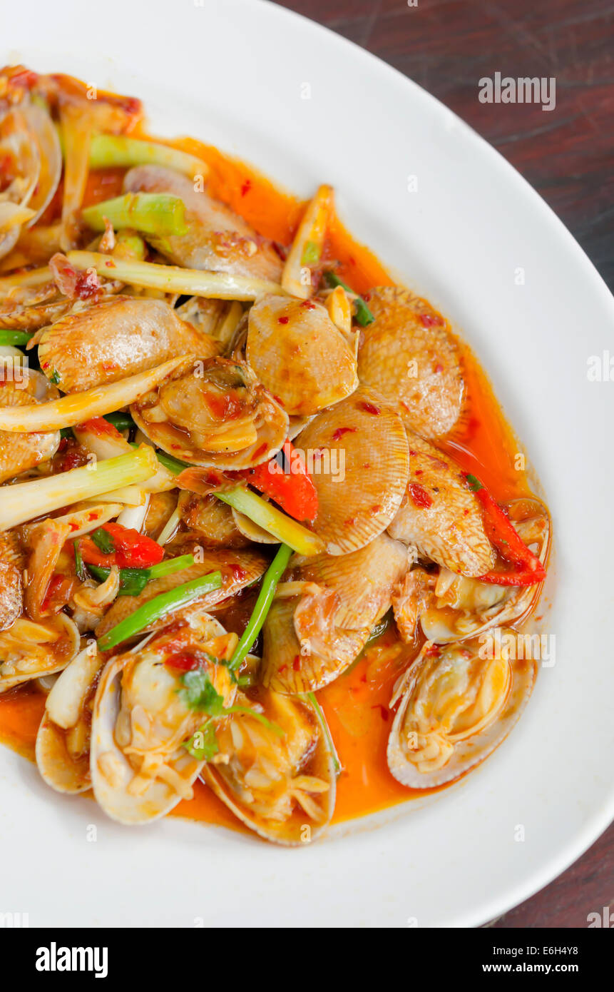 top view stir fried clams with roasted chili paste and thai basil leaves Stock Photo