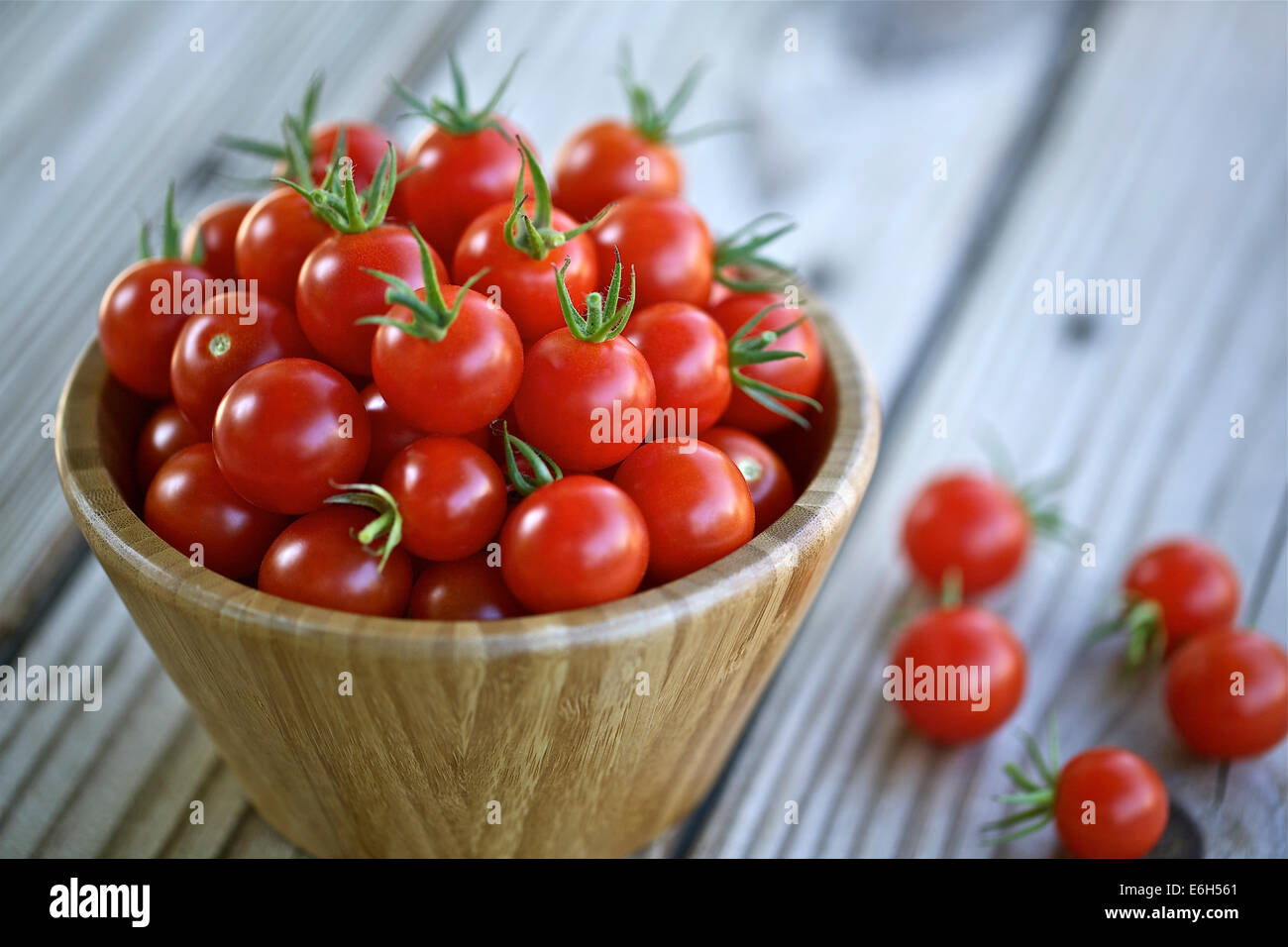 Cherry tomatoes in a wooden bowl Stock Photo - Alamy